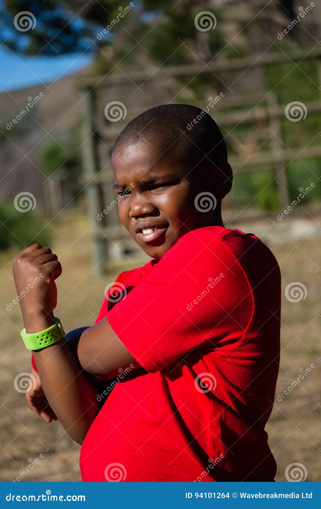 Boy Performing Stretching Exercise during Obstacle Course Training