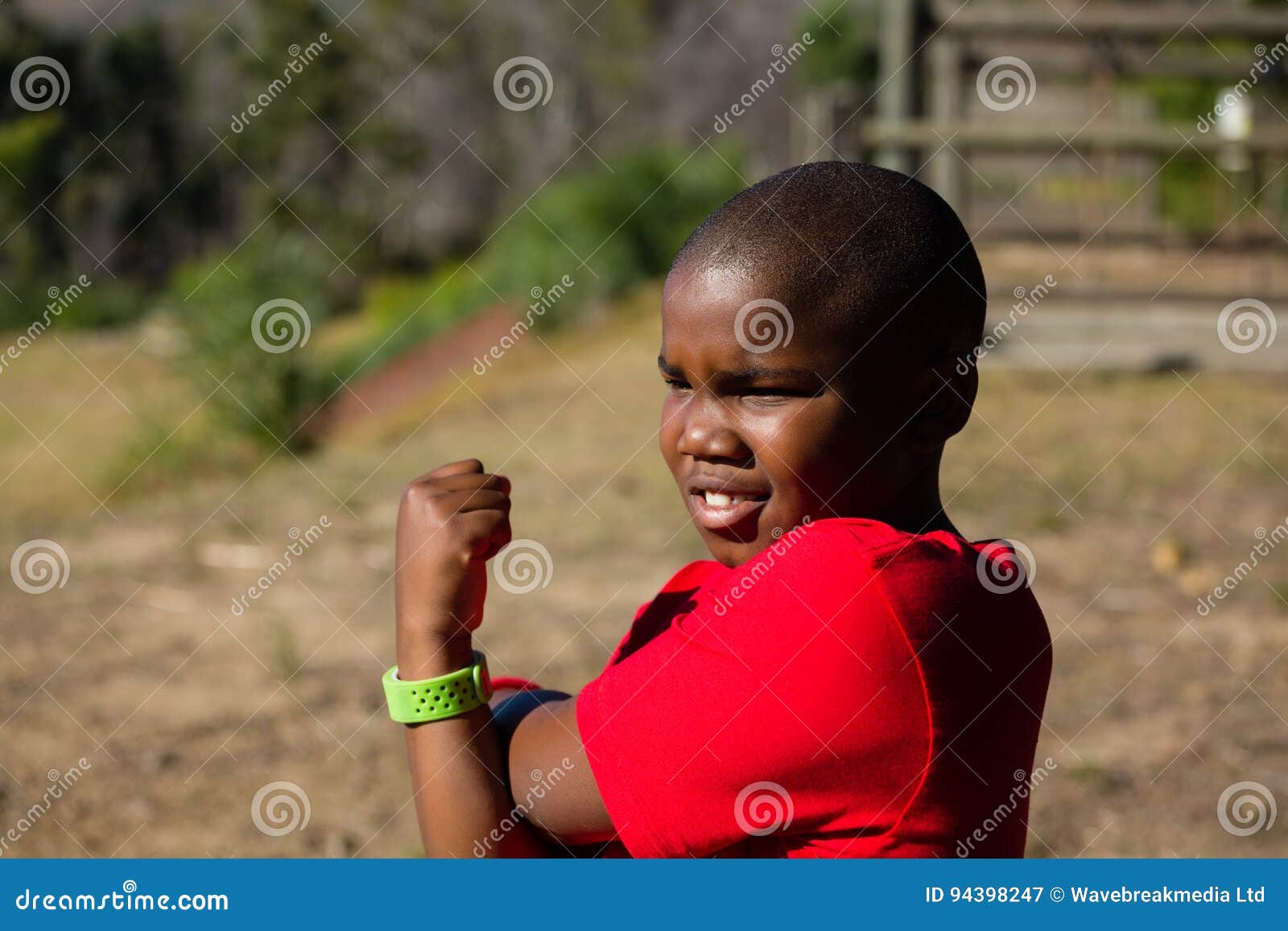 Boy Performing Stretching Exercise during Obstacle Course Training