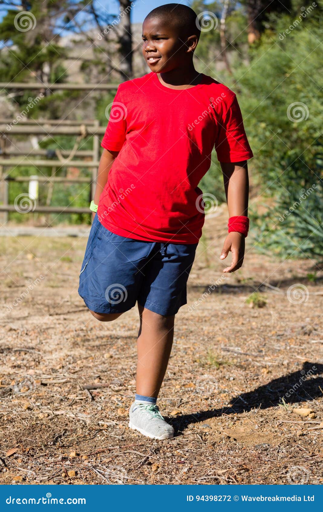 Boy Performing Stretching Exercise during Obstacle Course Training