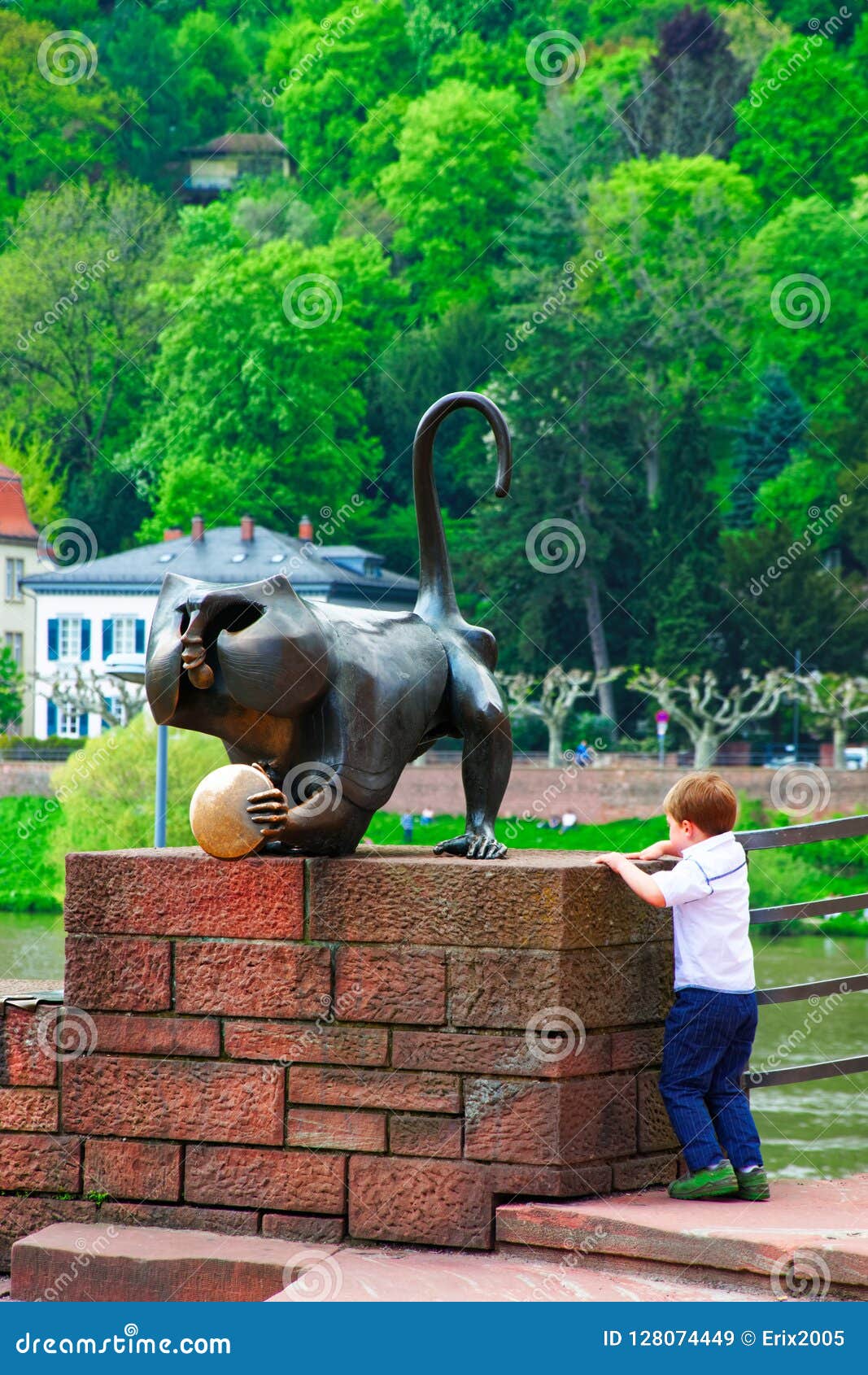 Boy Playing at Bronze Monkey Statue in Heidelberg Editorial Stock Image
