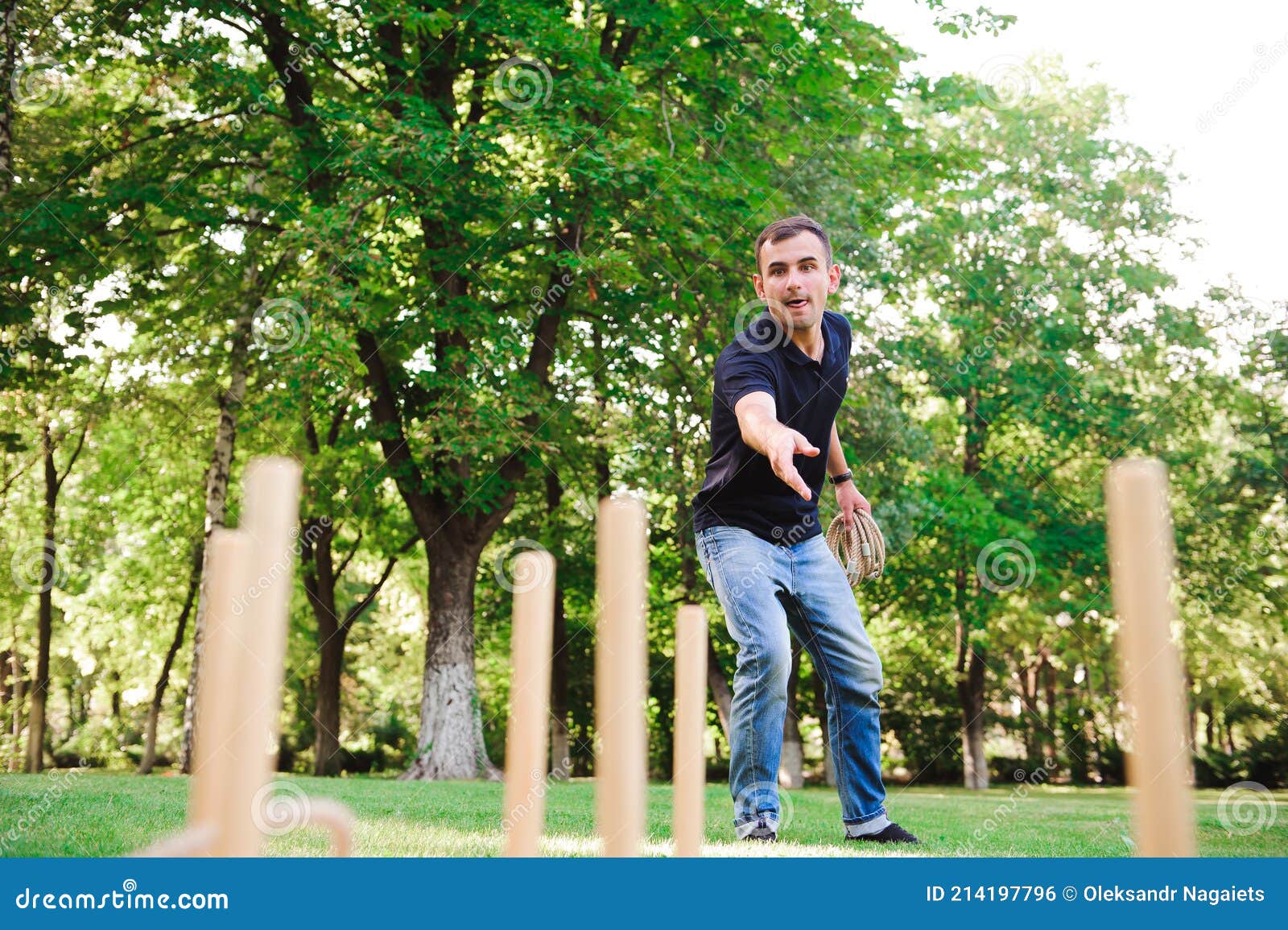 Boy Playing a Game Throwing Rings Outdoors in Summer Park. Stock Photo