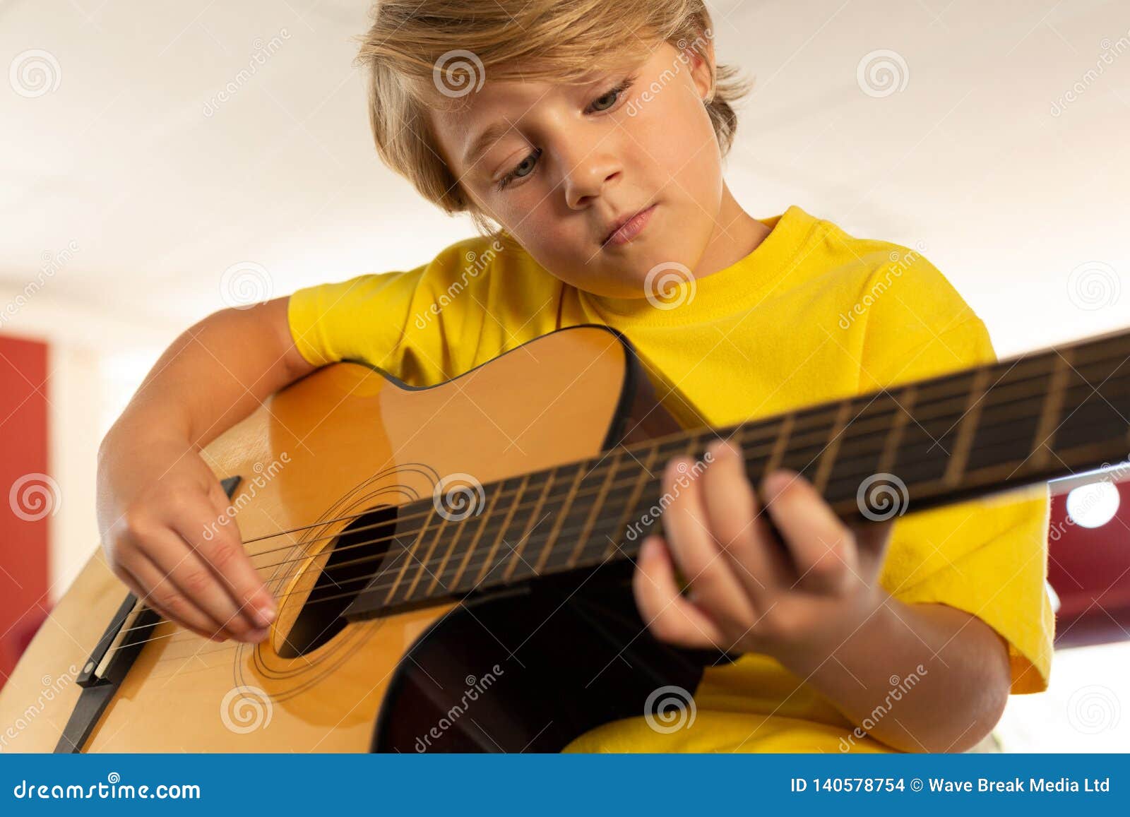 Boy Playing Guitar in a Classroom Stock Photo Image of musical