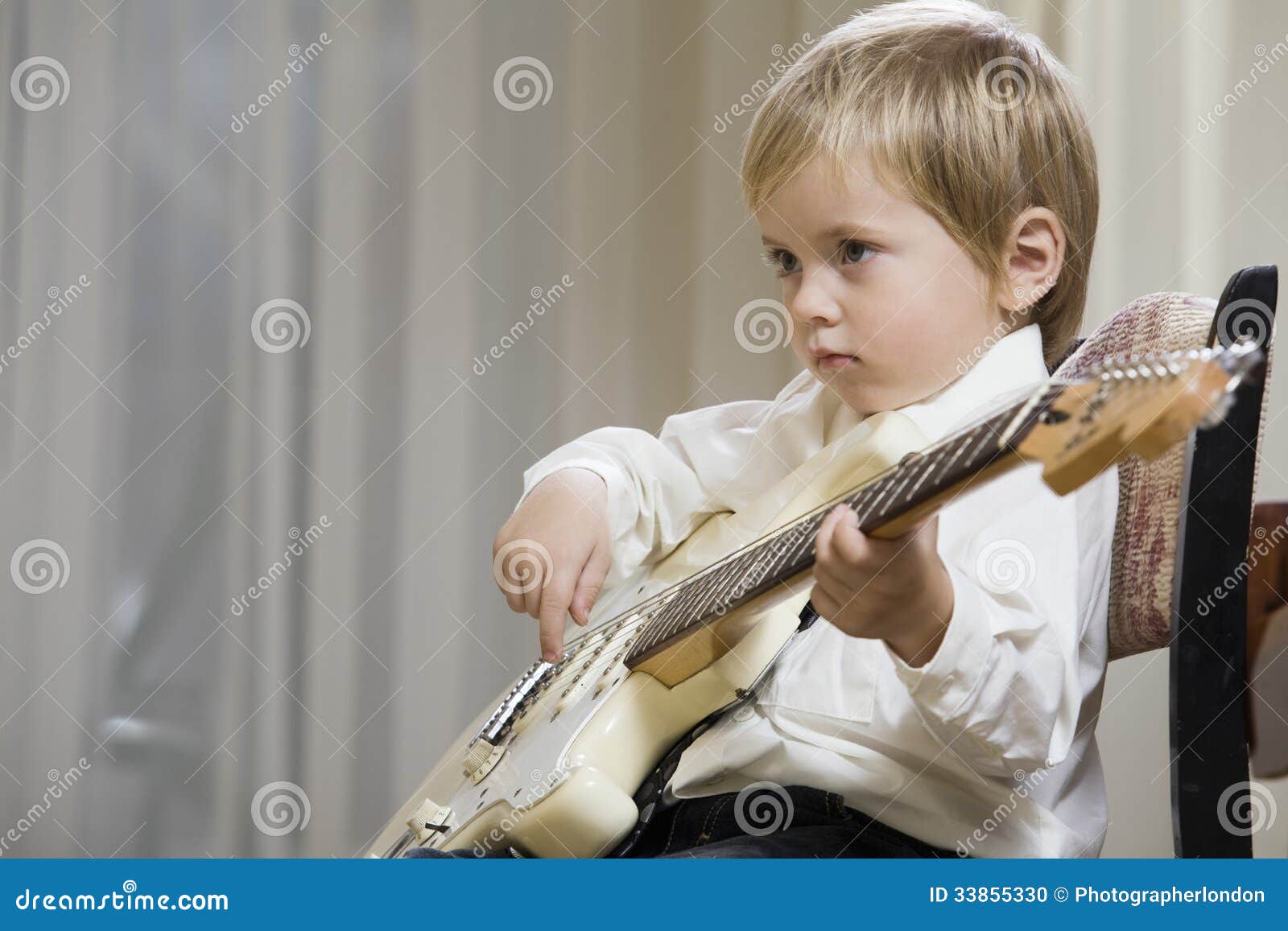 cute boy playing guitar