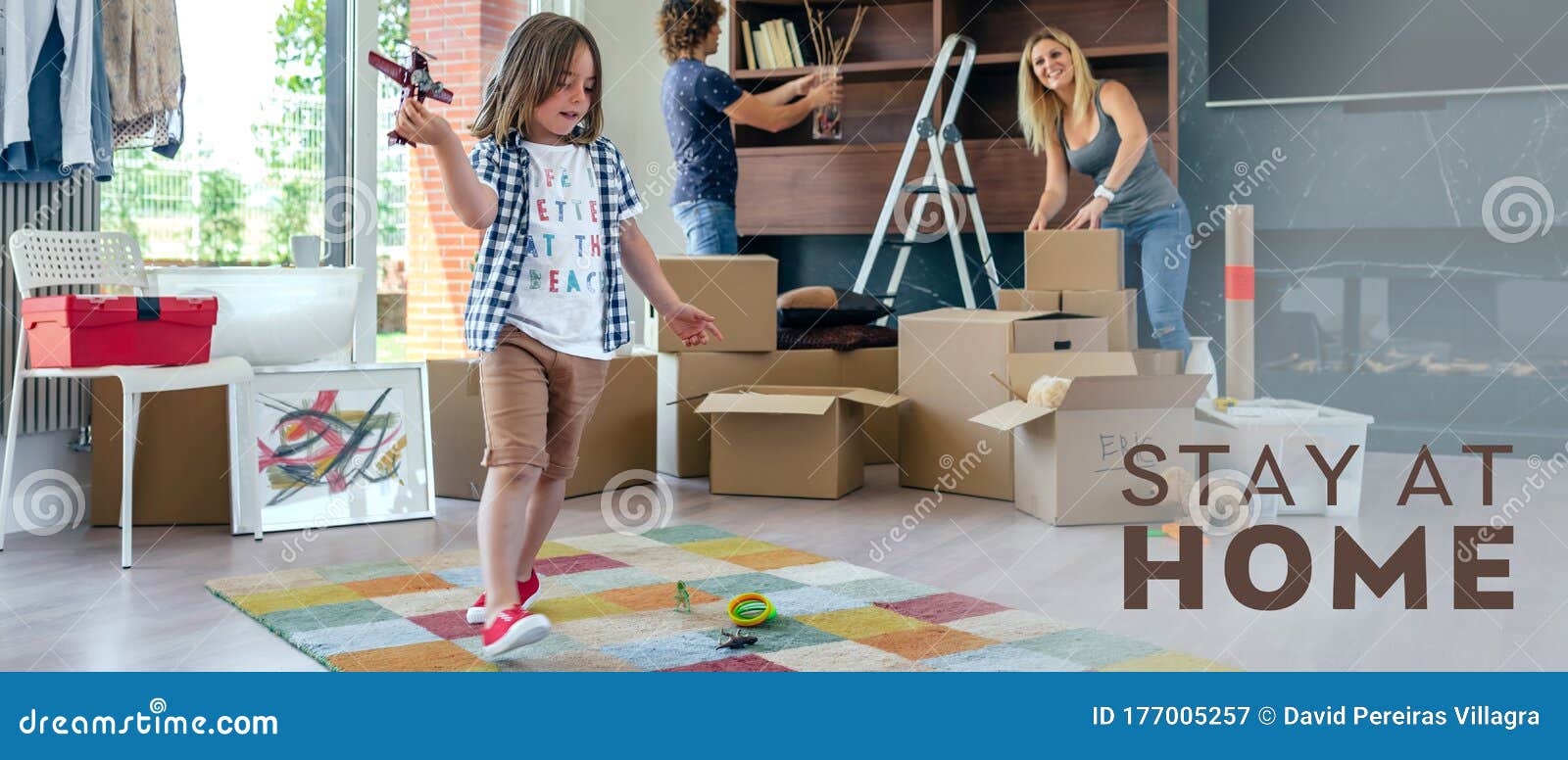 Boy Playing With Toy Airplane While Parents Unpack Stock Image Image