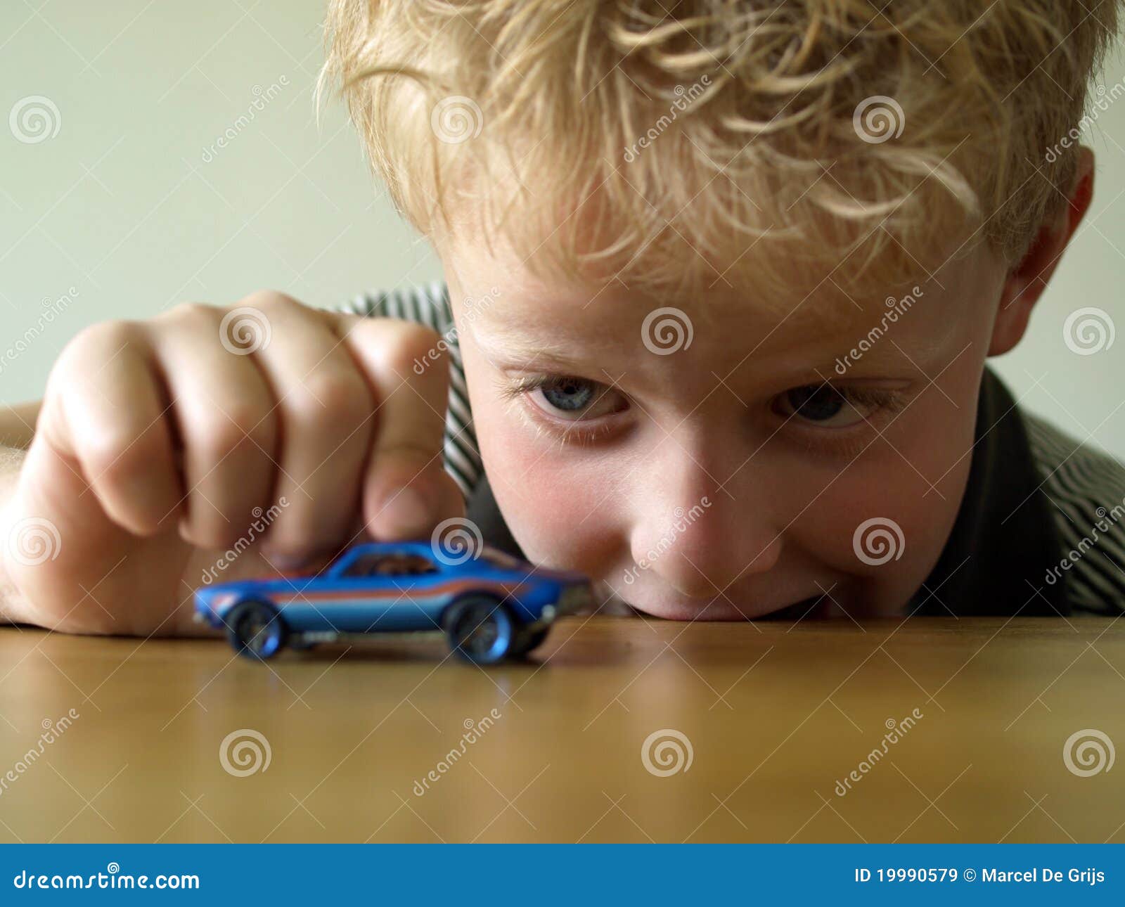 Boy playing with toy car stock image. Image of speculate 19990579