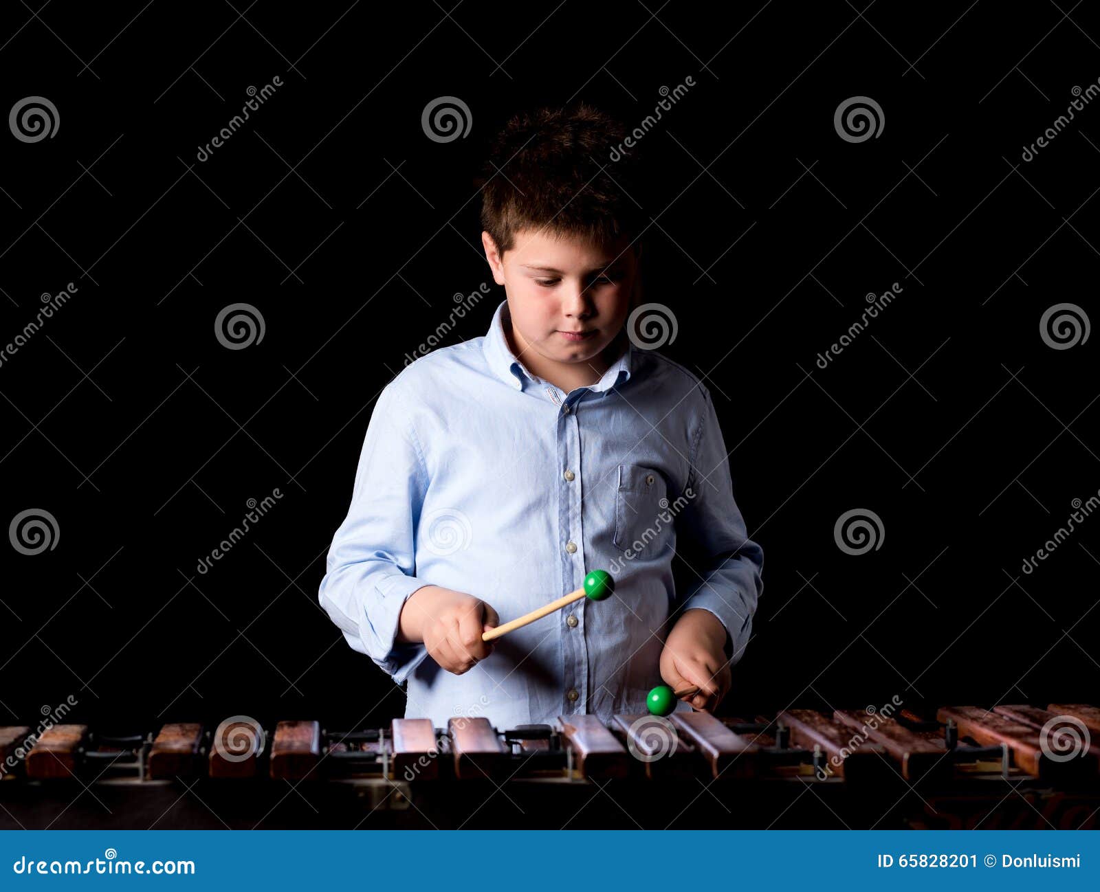 Boy playing on xylophone stock image. Image of black 65828201