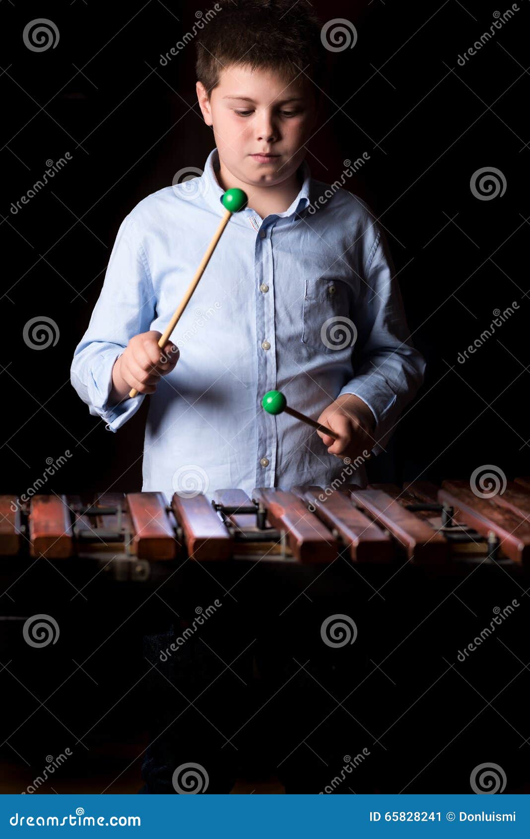 Boy playing on xylophone stock image. Image of person 65828241