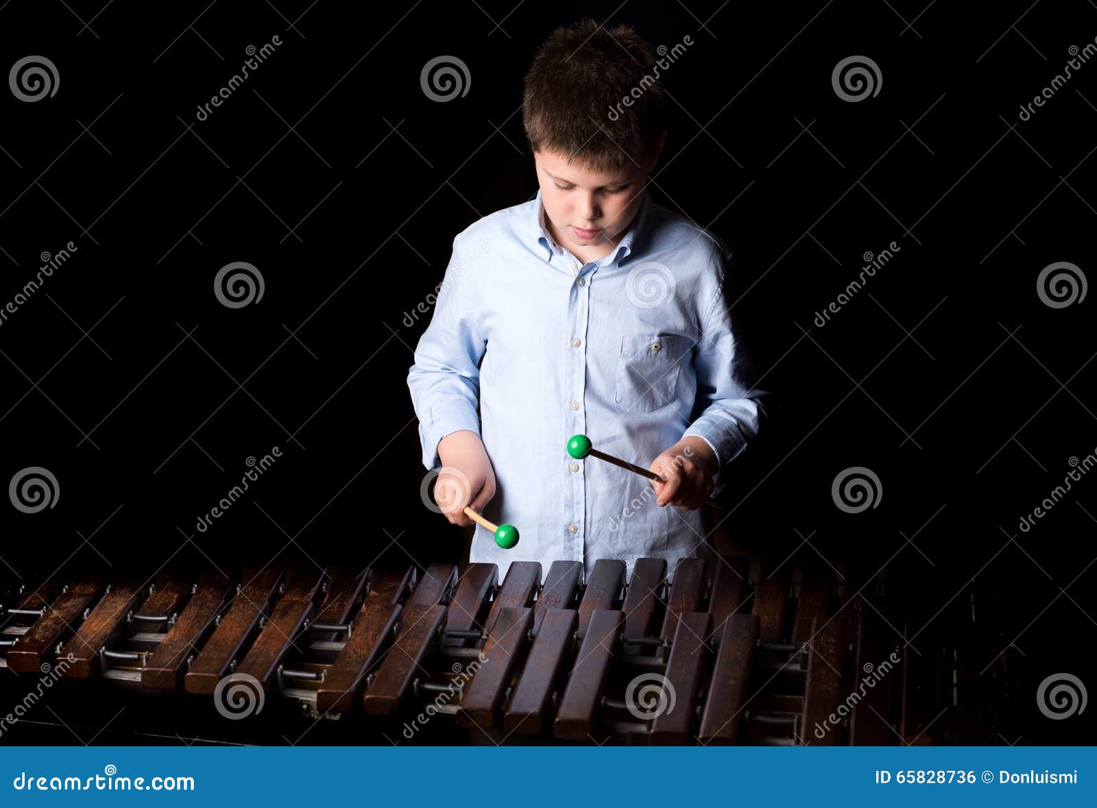 Boy playing on xylophone stock photo. Image of brown 65828736