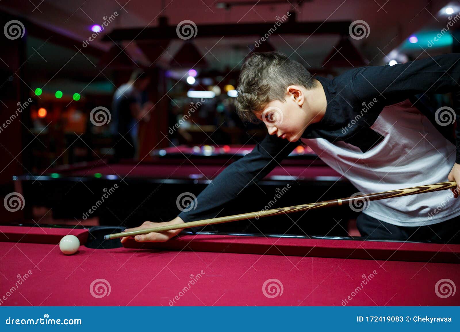 Boy Plays Billiard Or Pool In Club Young Kid Learns To Play Snook