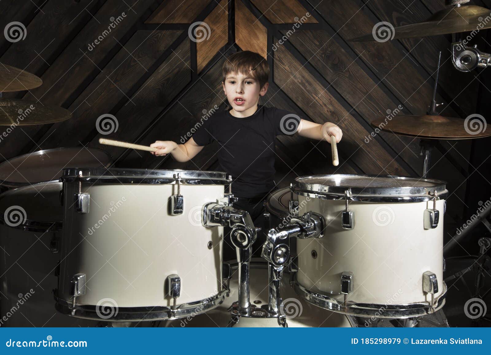 The boy plays the drums. stock image. Image of music 185298979