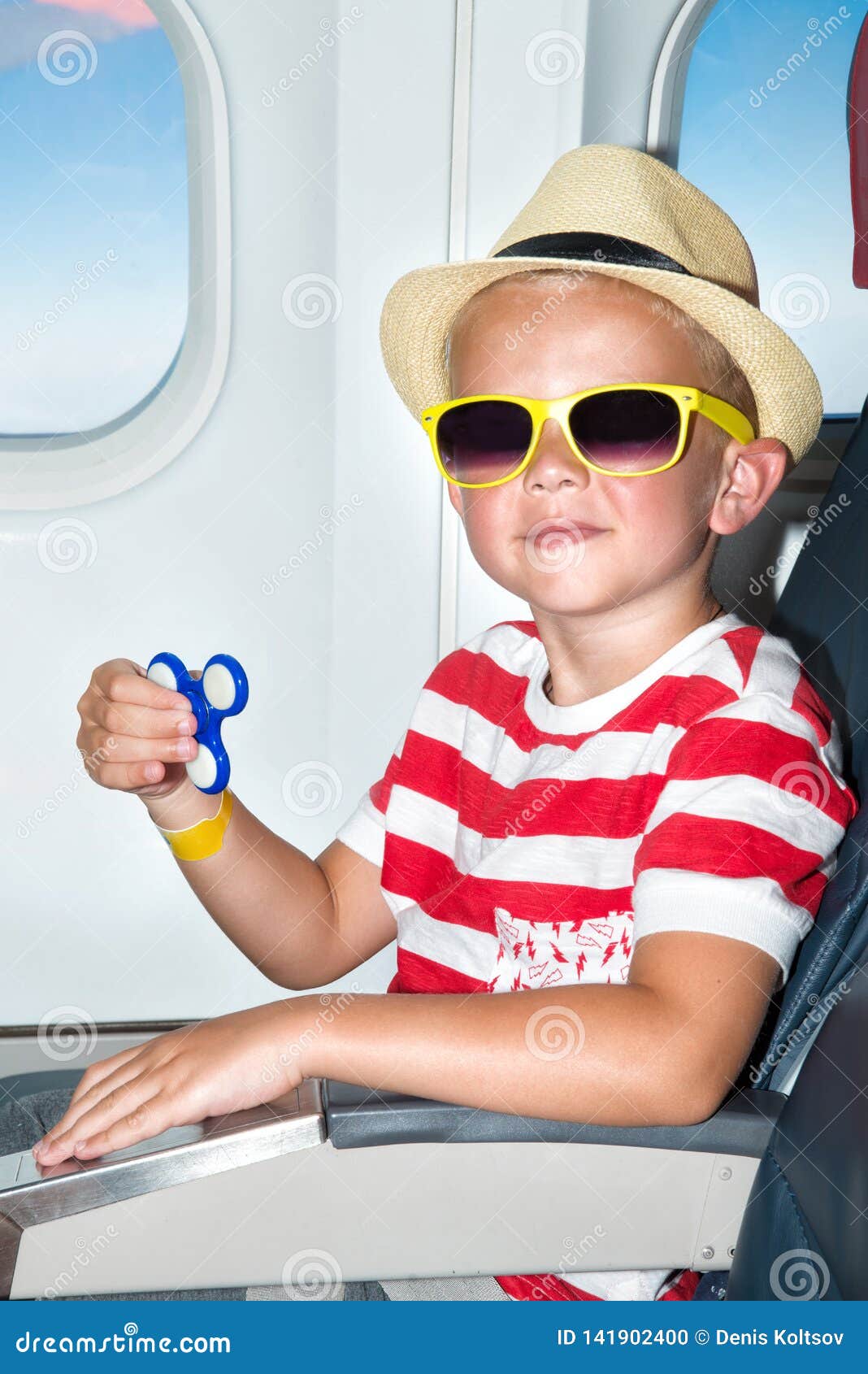 The Boy Plays with the Spinner on the Plane.Fancy Toys. Stock Photo