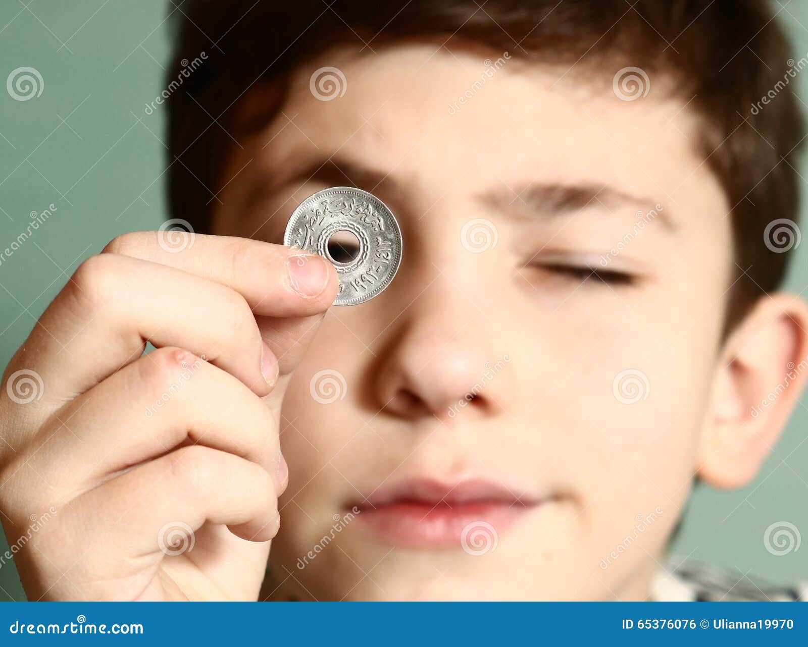 boy preteen numismatic collector show his coin