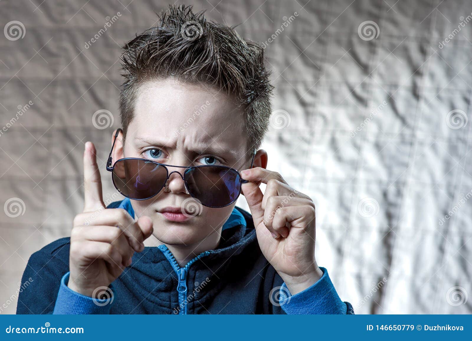 Boy Raised His Finger Reproachfully and Raised His Eyebrows To His