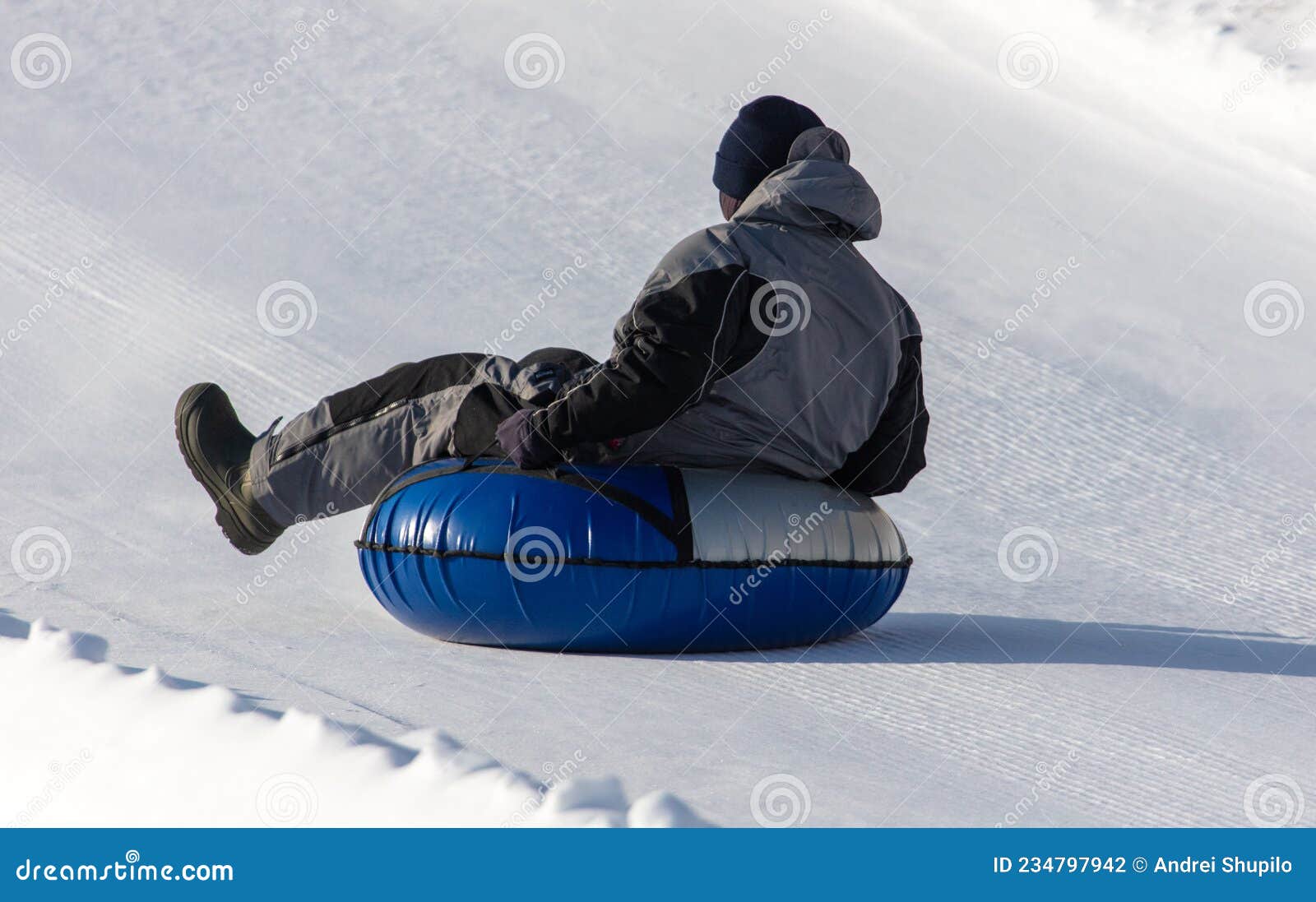The Boy Rolls Down the Mountain on a Tubing Stock Photo Image of