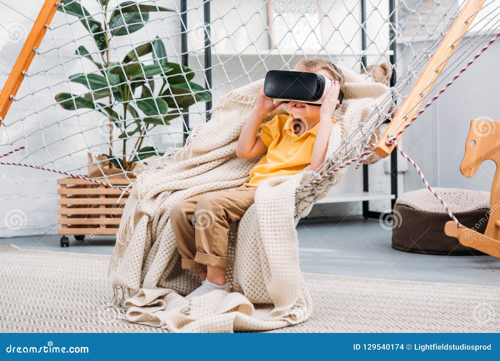 boy in rope hammock using virtual