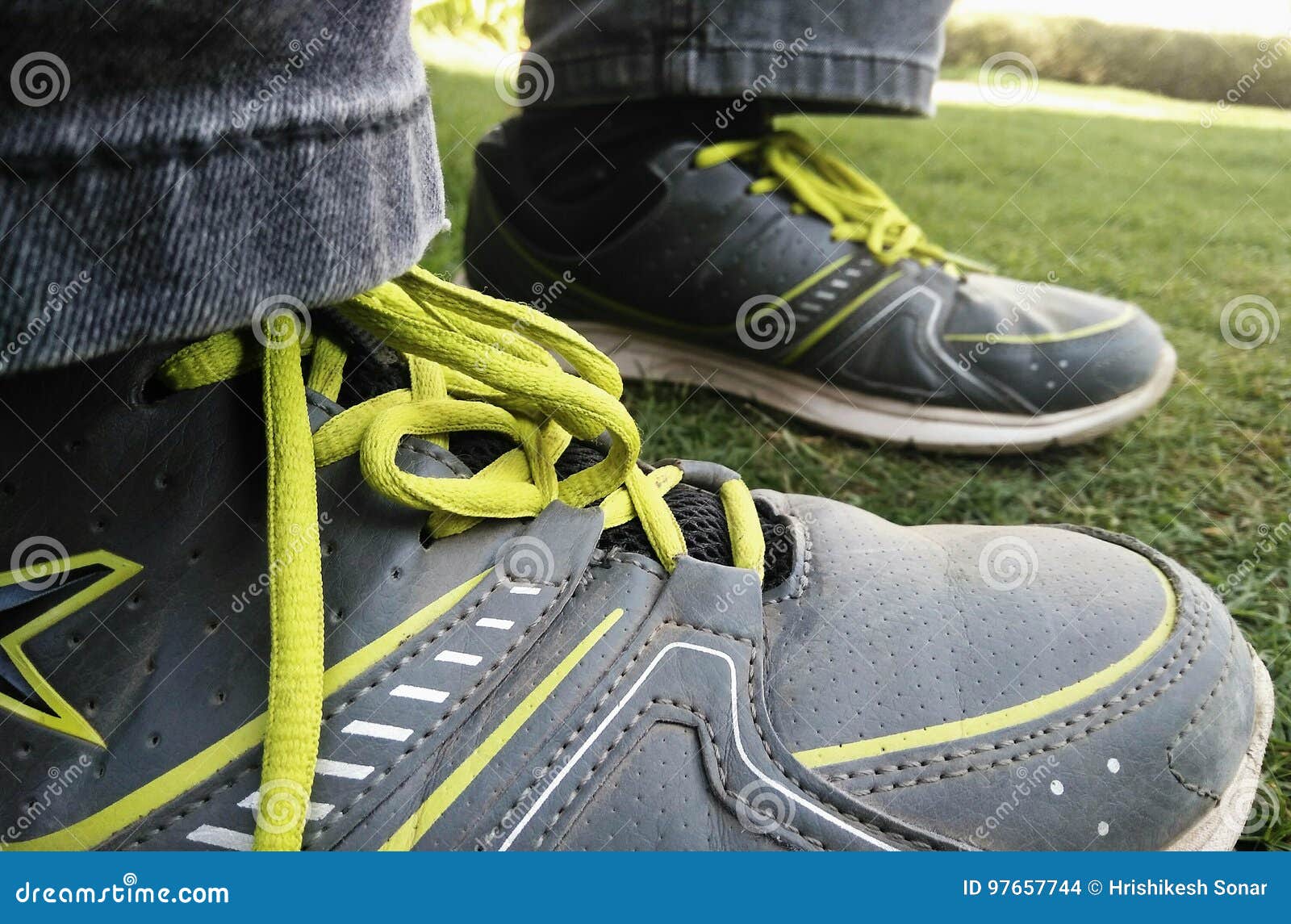 Boy`s Legs on Grass Sitting Alone in Park Wearing Sport Shoes. Stock ...