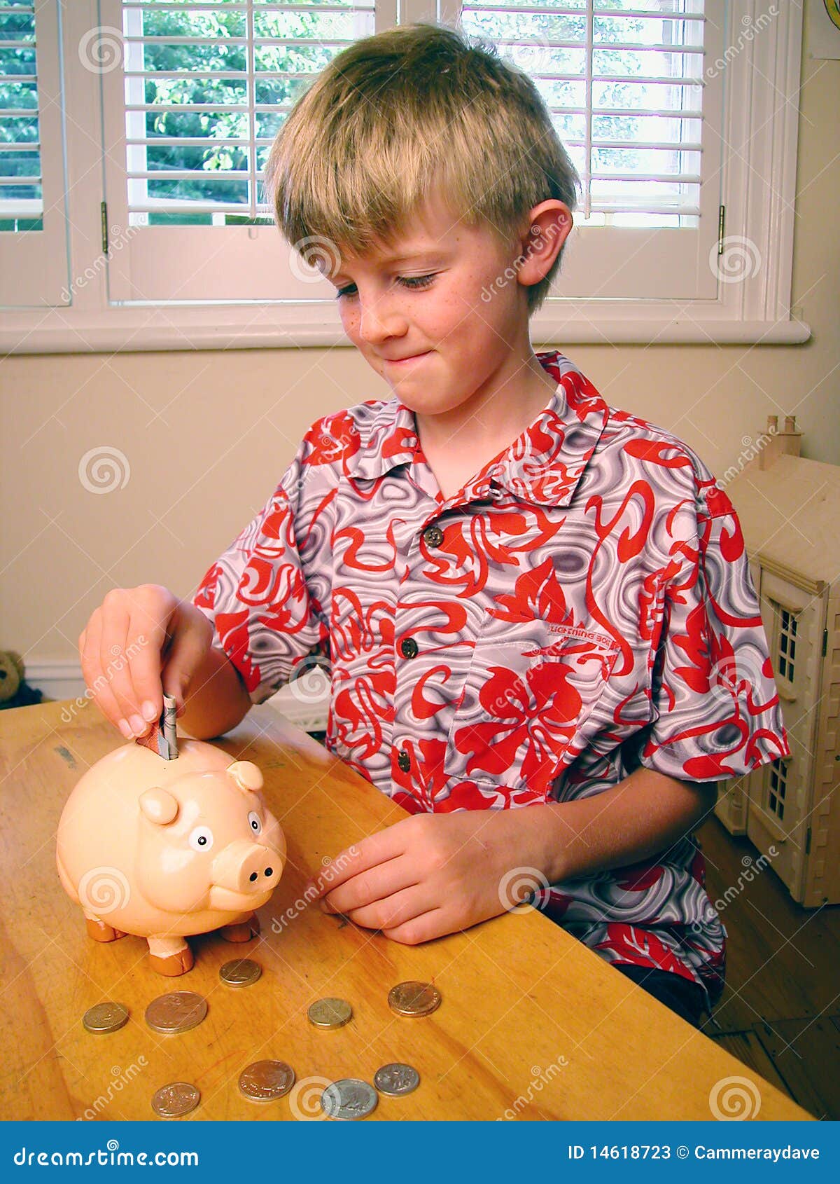 Boy Saving Money Piggybank stock image. Image of putting 14618723