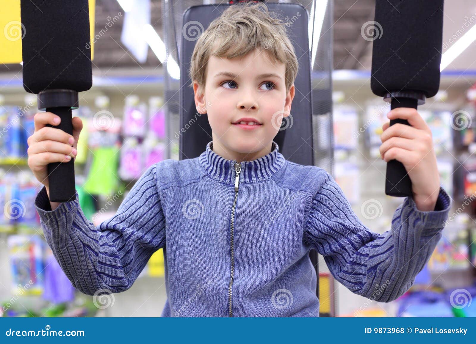 boy in shop on sports exerciser