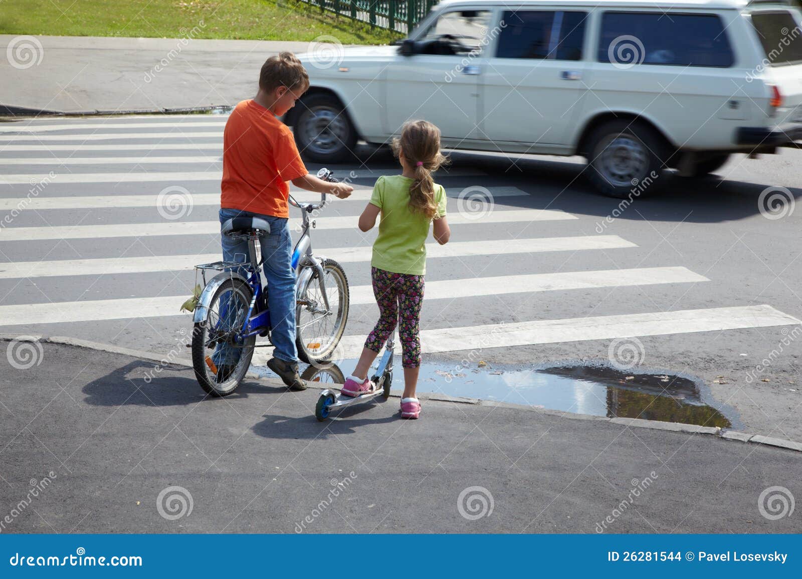 boy and sister stand before zebra crossing