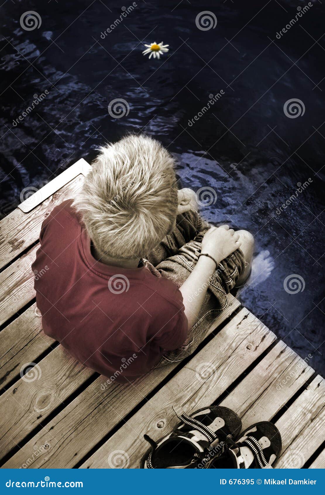 boy sitting on a footbridge alone