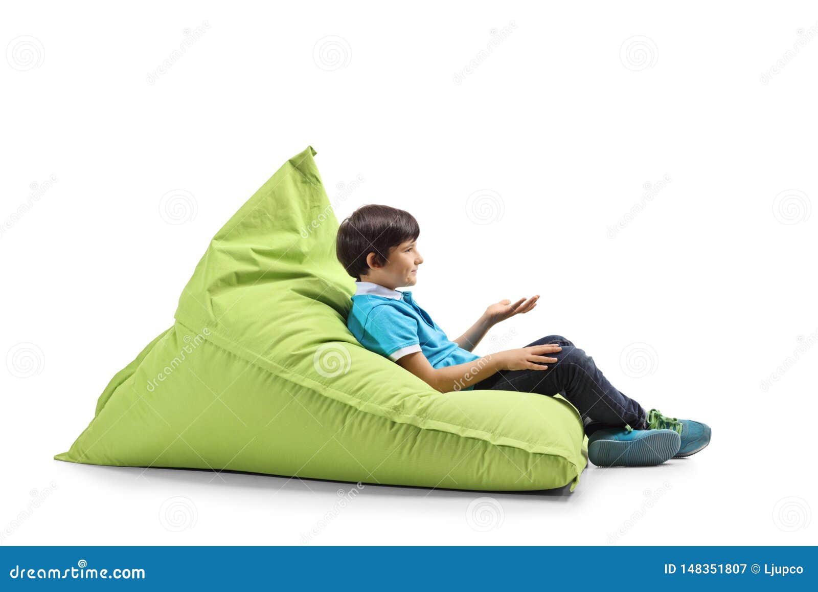 Boy Sitting on a Green Bean Bag and Gesturing with Hand Stock Image ...