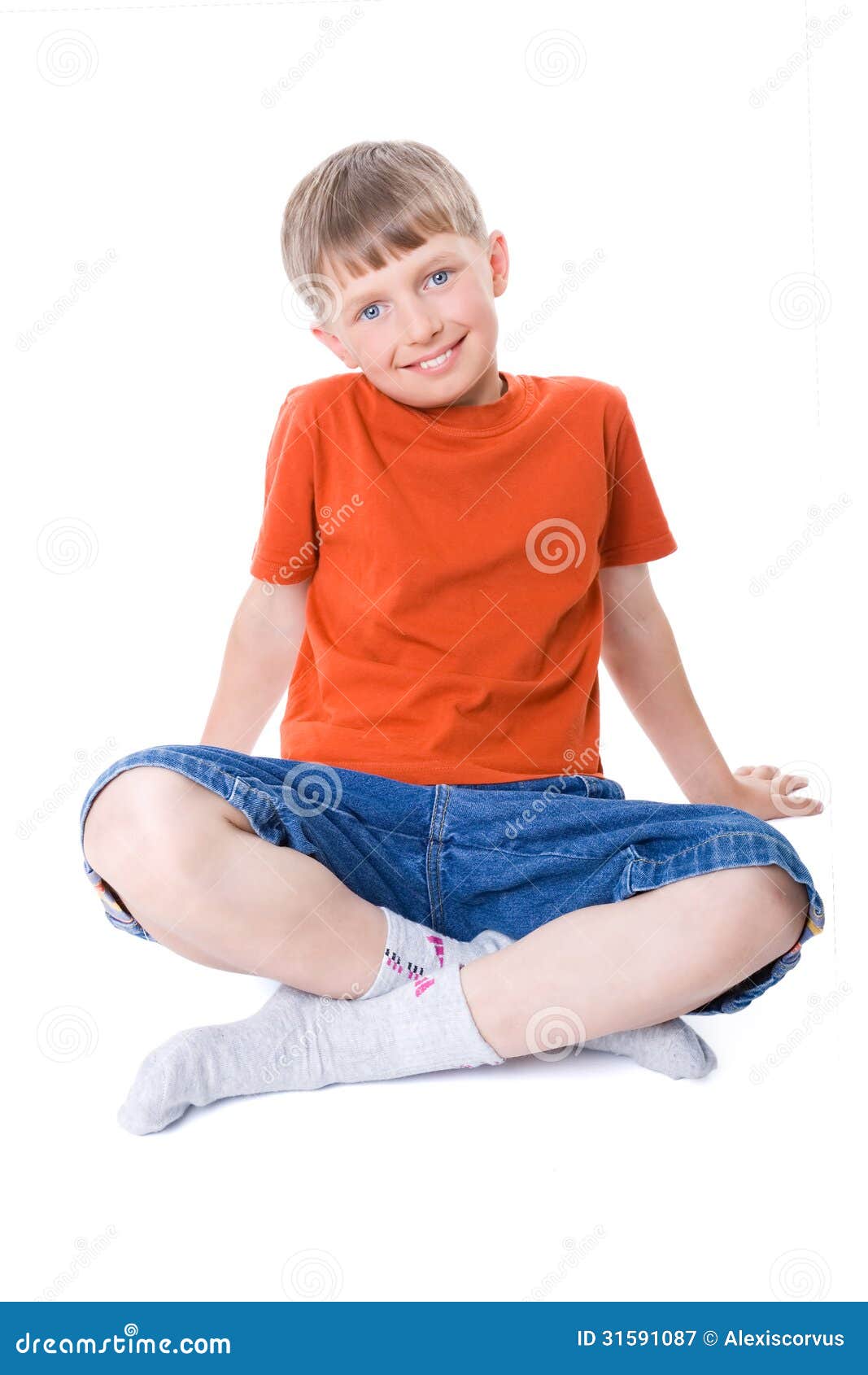 A Boy Sitting with Legs Crossed Stock Image Image of jeans