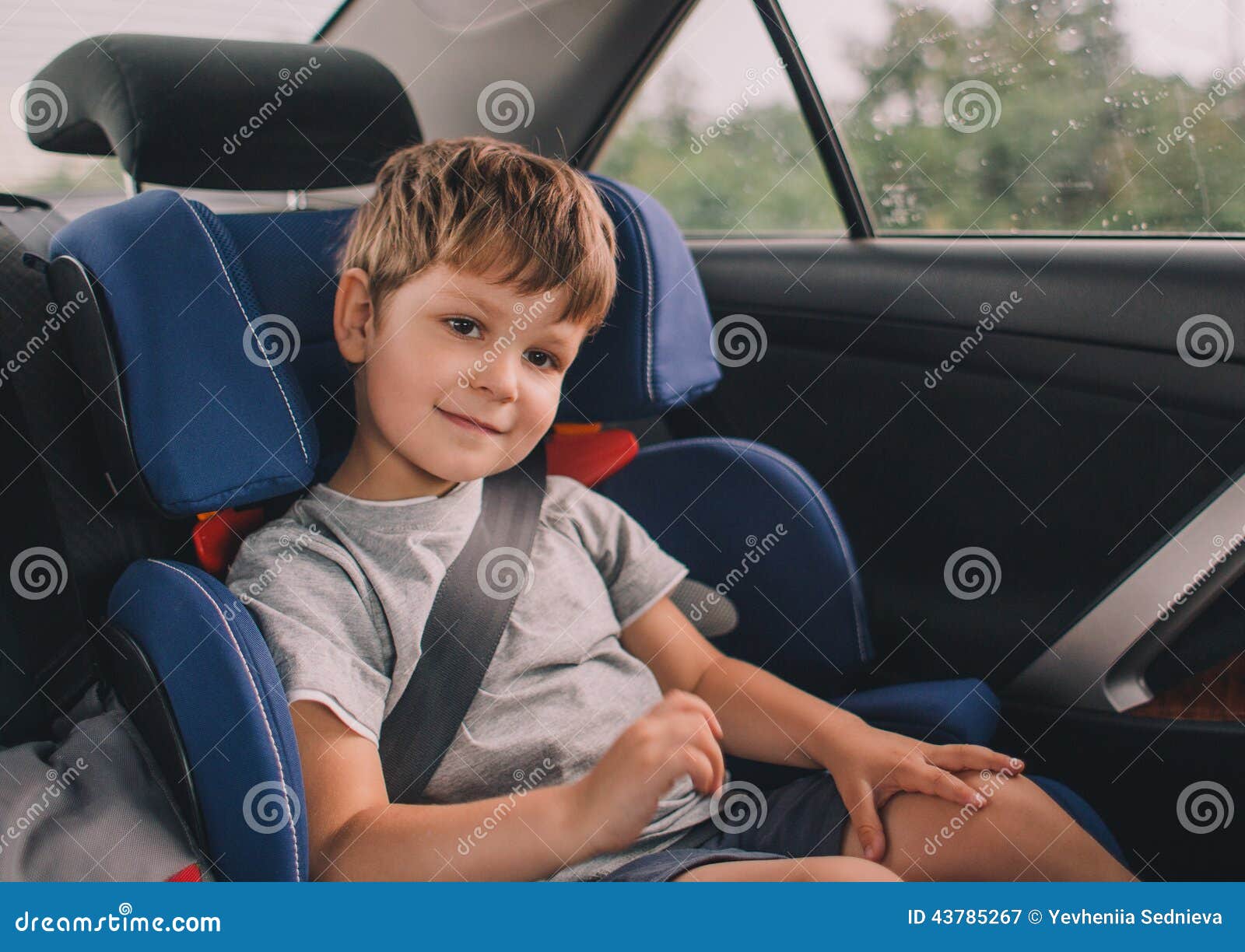 boy sitting in safety car seat