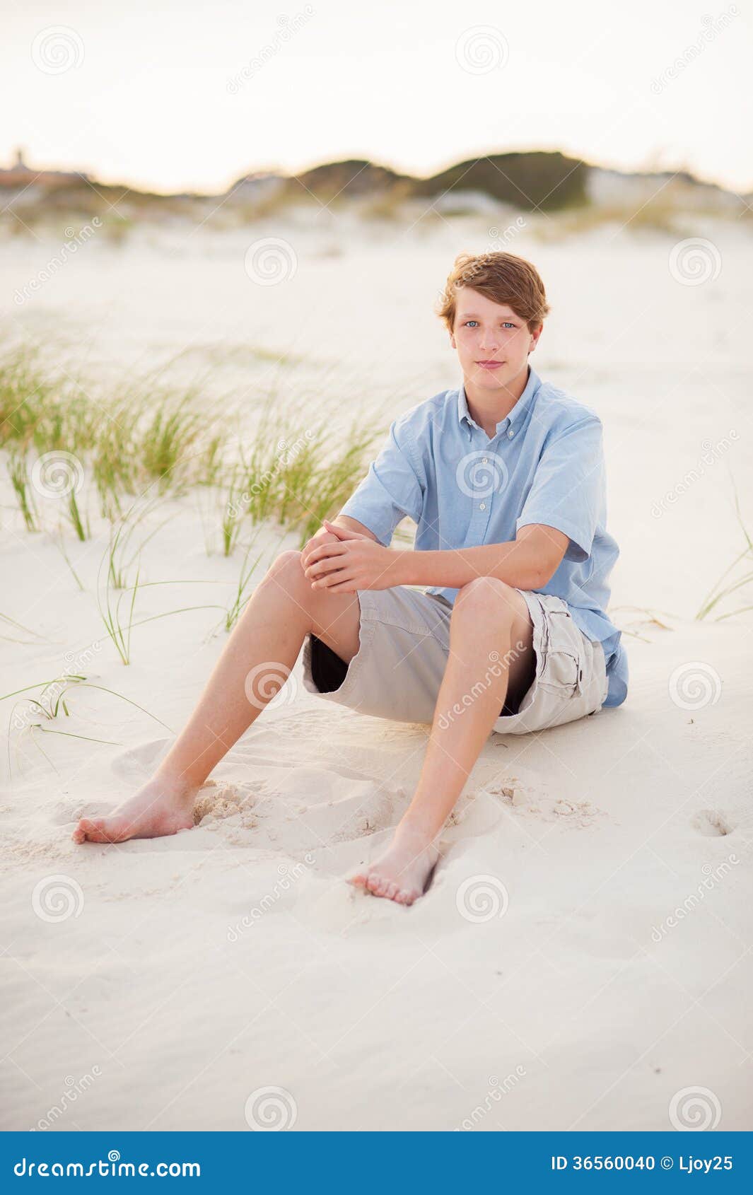 Boy sitting in the sand stock photo. Image of handsome - 36560040