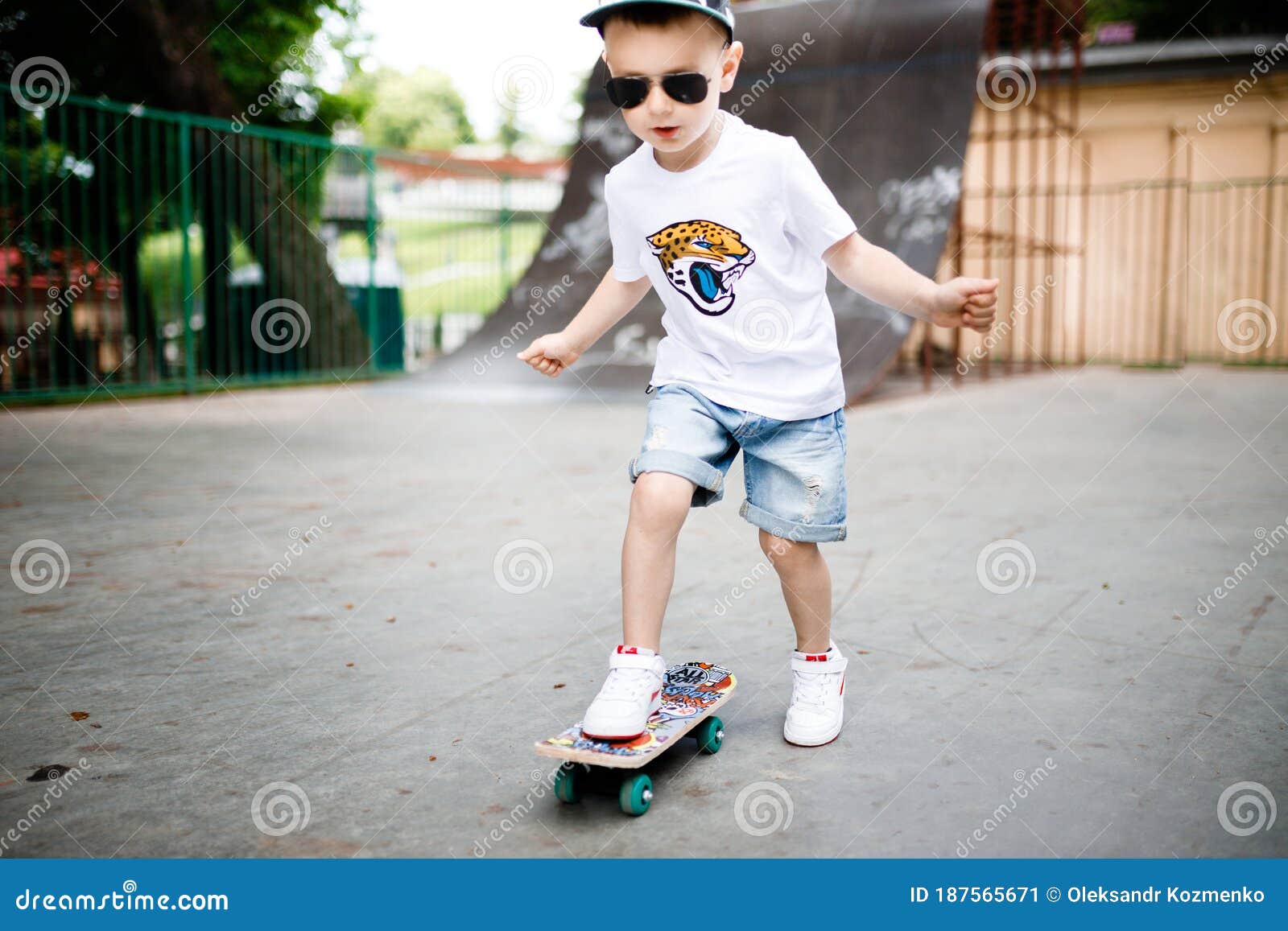 Boy with a Skate in a Skate Park. a Boy with Glasses Learns To Skate ...