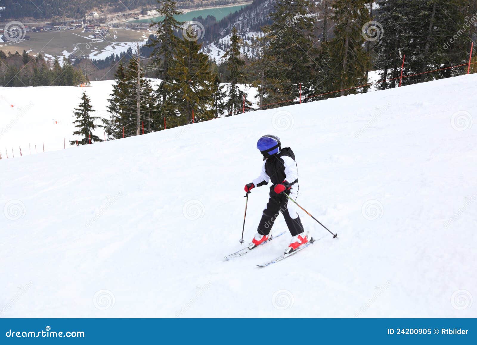 Boy is skiing. Young boy is looking down on track