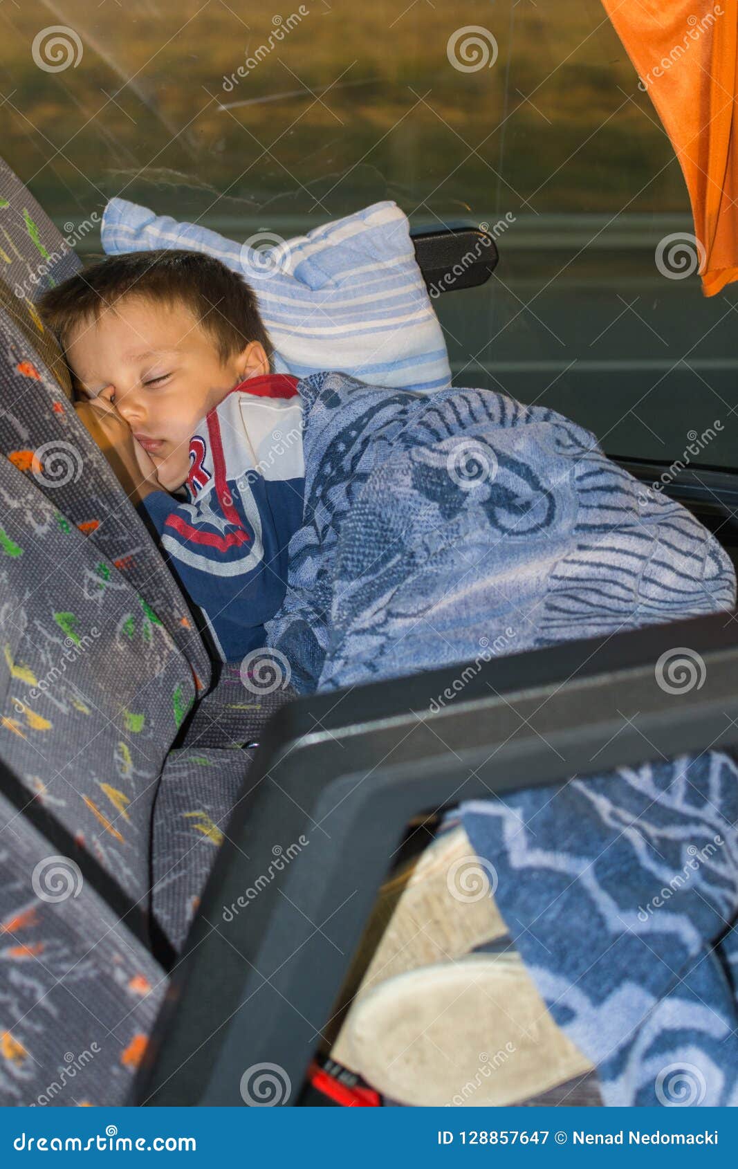 The boy sleeps on the bus stock image. Image of male 128857647