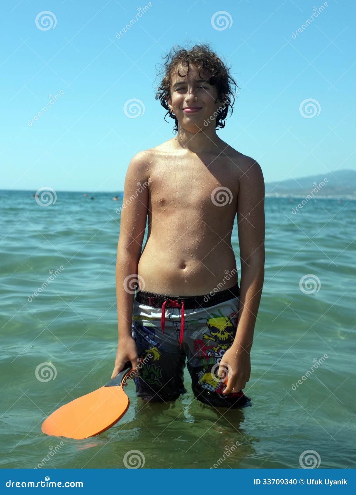 Teen boy with water, Stock image