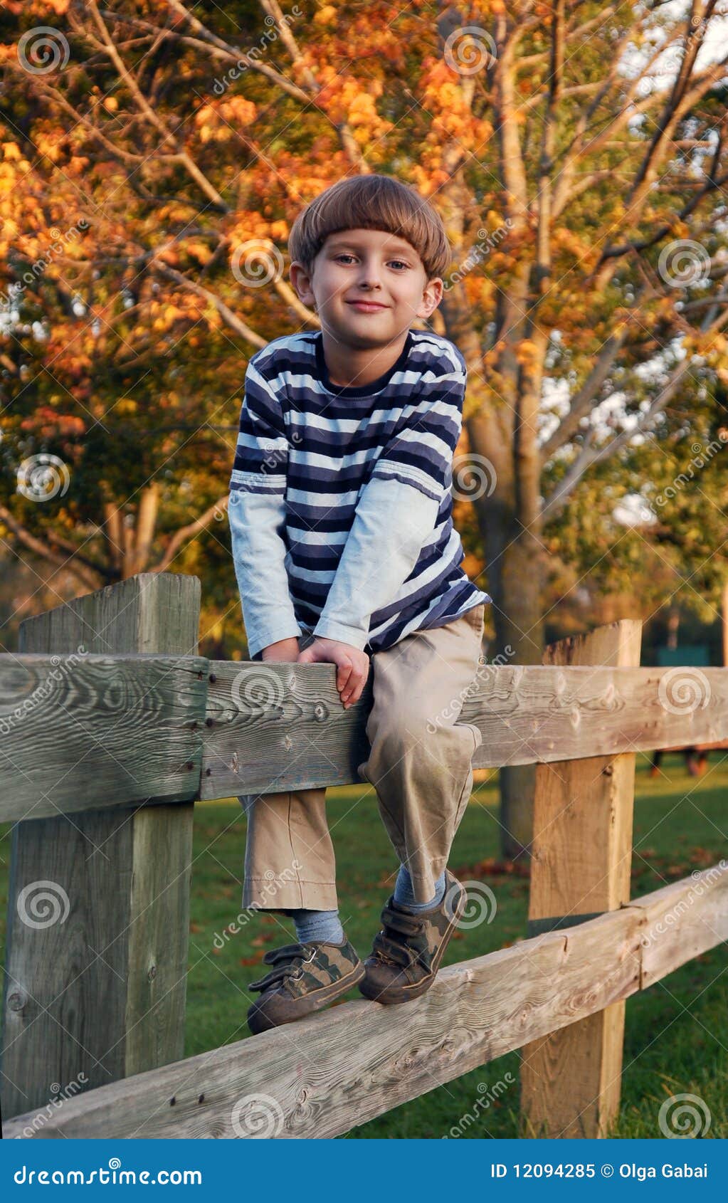boy straddling on the fence