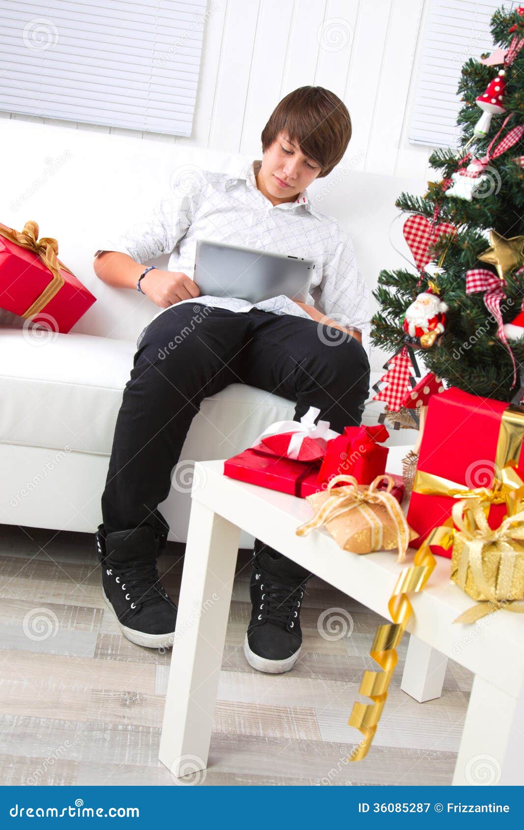 boy surfs on laptop in christmas