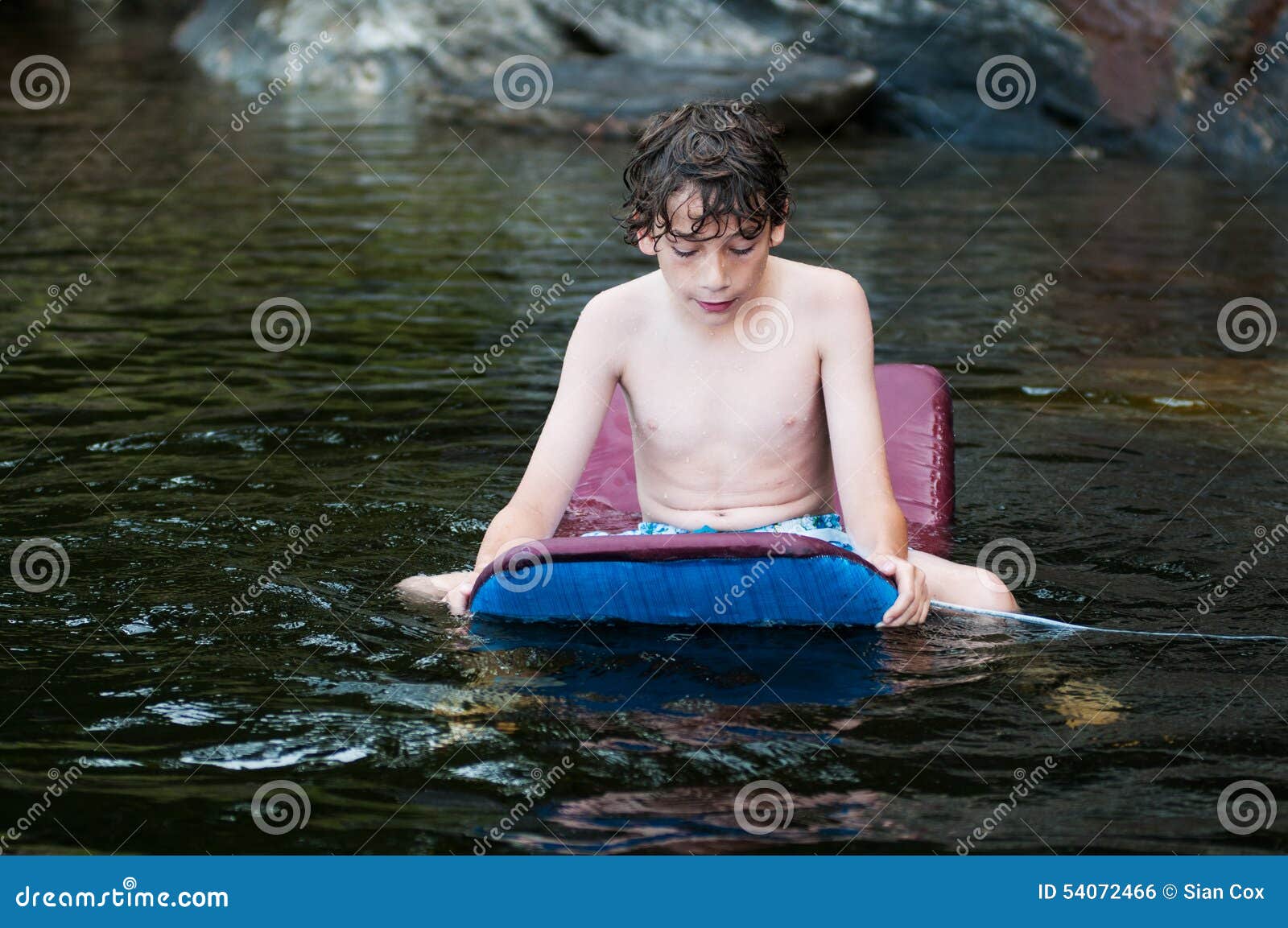 Boy swiming in a lake stock photo. Image of childhood 54072466