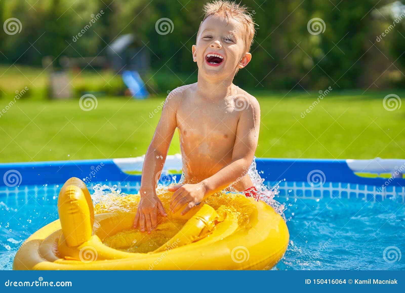 Cute Boy Swimming and Playing in a Backyard Pool Stock Photo Image of