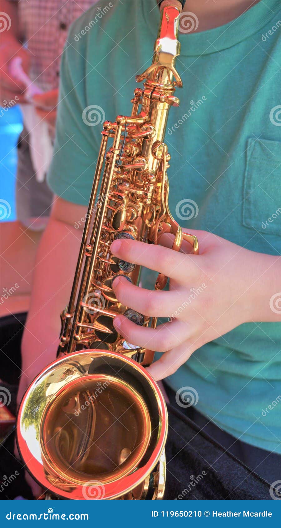 Young Man Plays Mini Saxophone with Bare Hands Stock Photo - Image