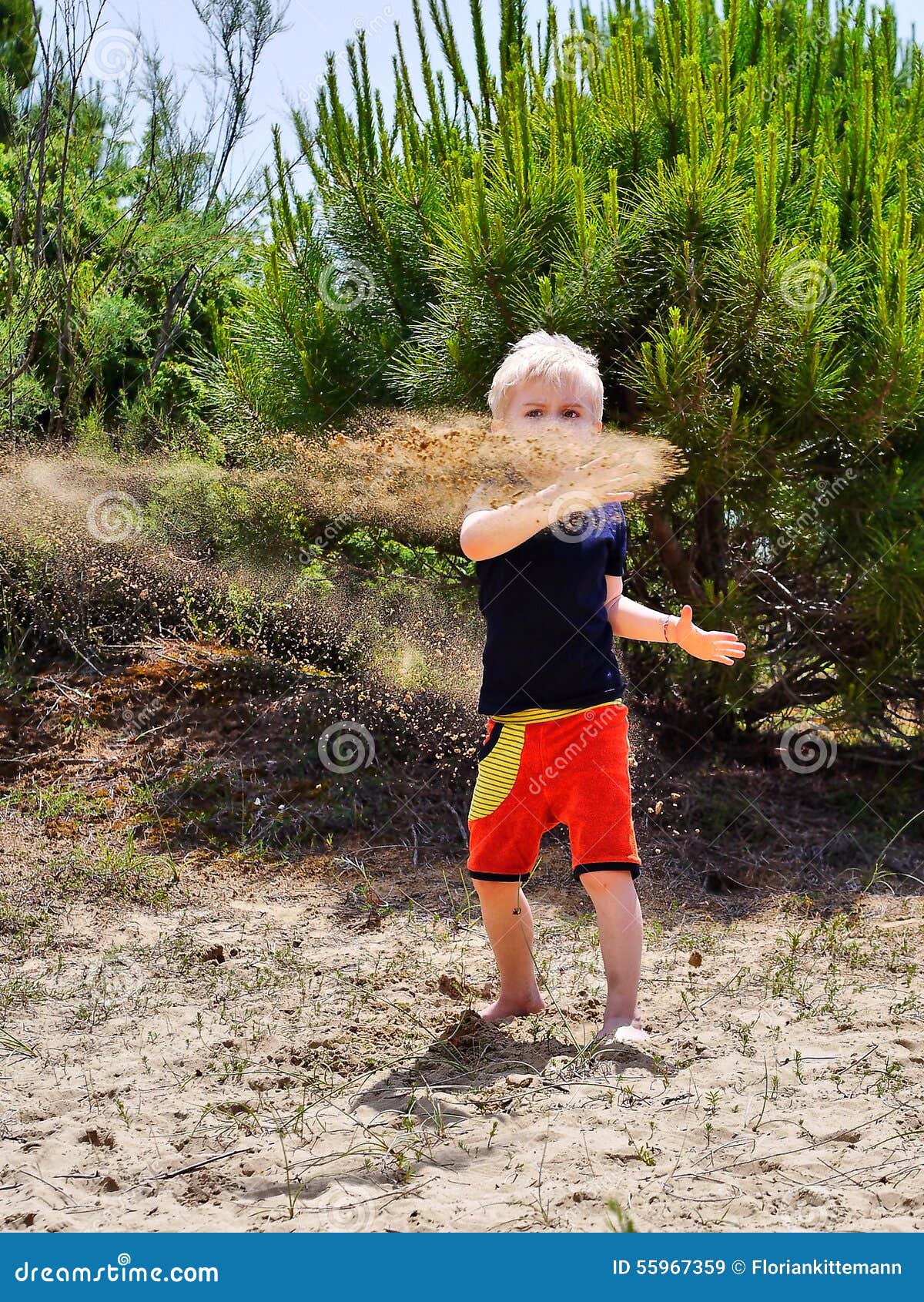 Boy throwing sand stock image. Image of place, lost, coastal 55967359