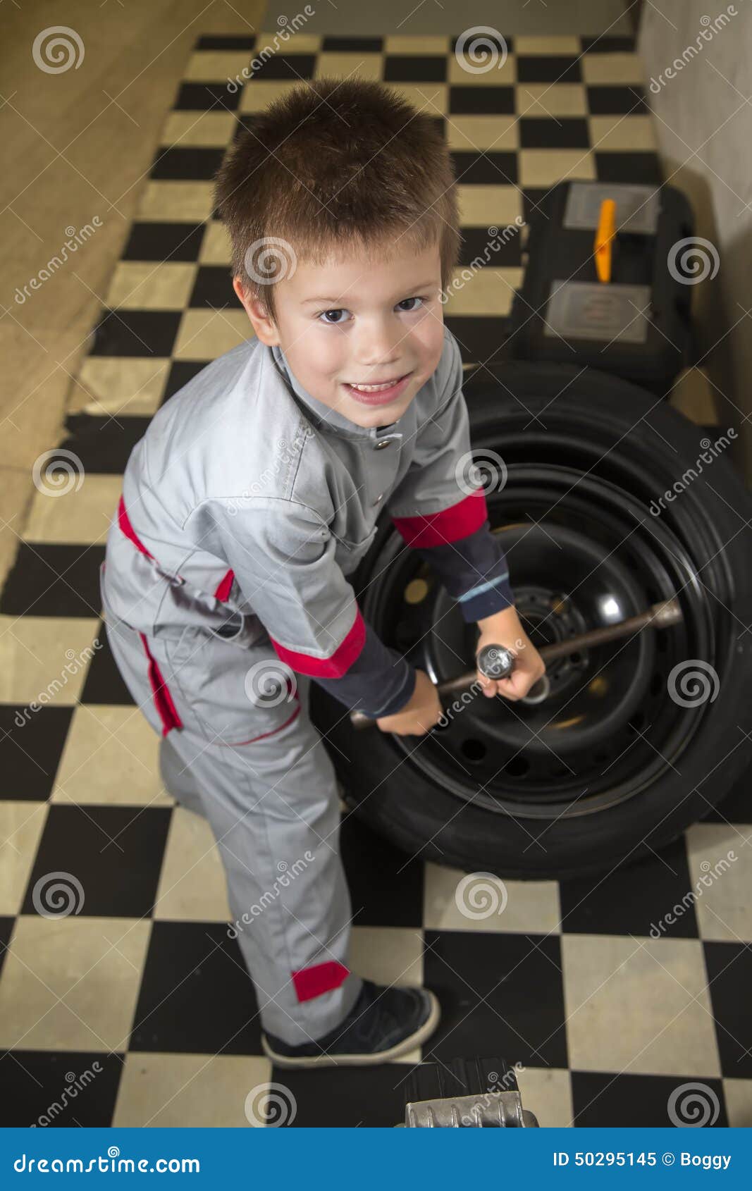 Boy and tires stock image. Image of servicing, child 50295145