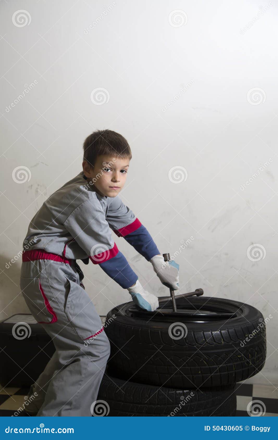 Boy and tires stock image. Image of work, wheel, 50430605