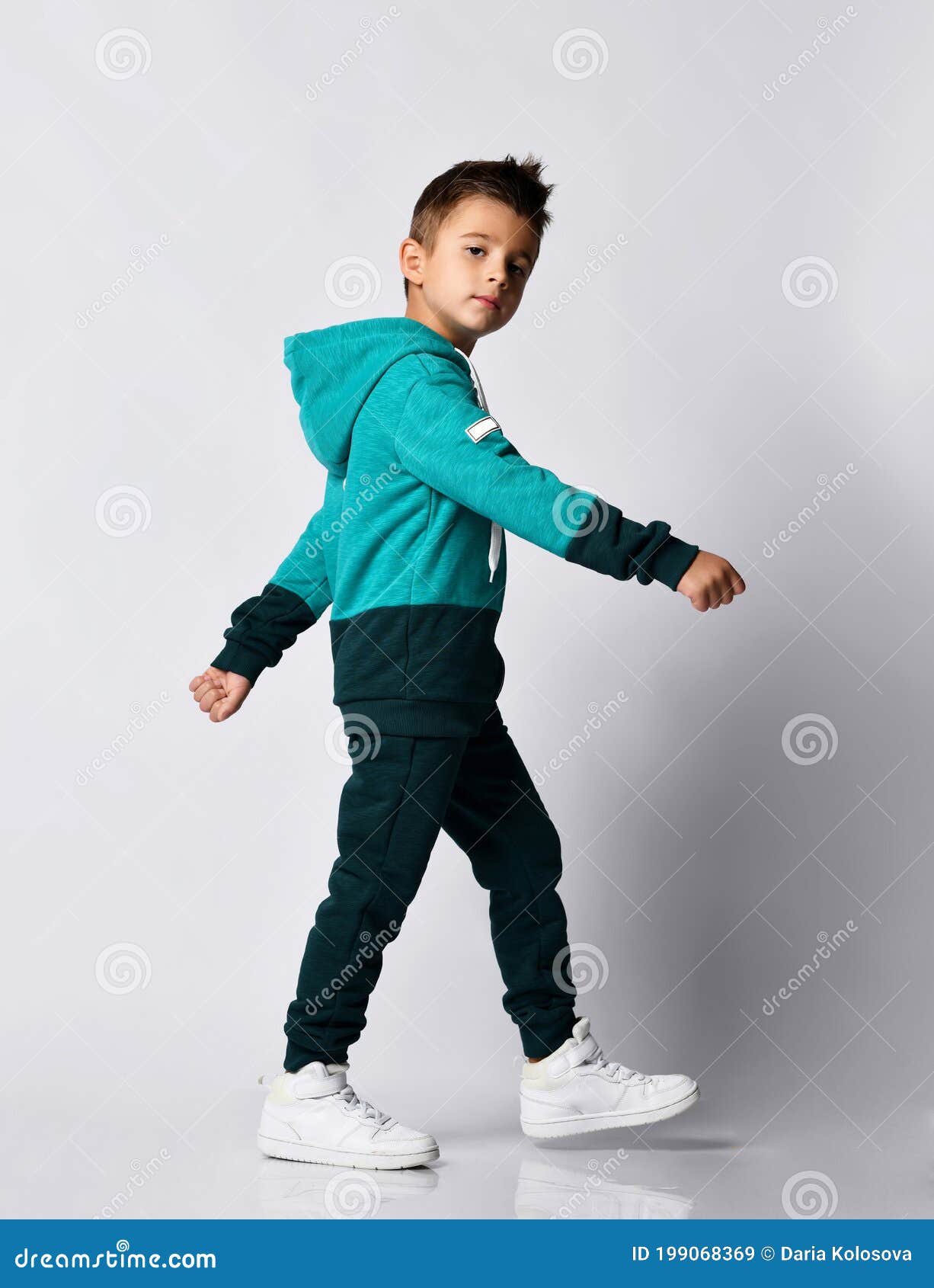 Boy in Tracksuit, Sneakers Walking Isolated on Grey Stock Image - Image ...
