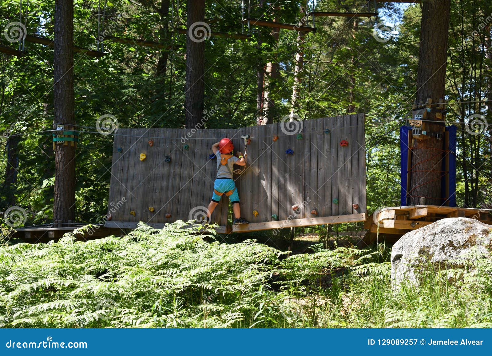 A Boy Trying To Conquer a Wall Climbing Obstacle Editorial Photography ...