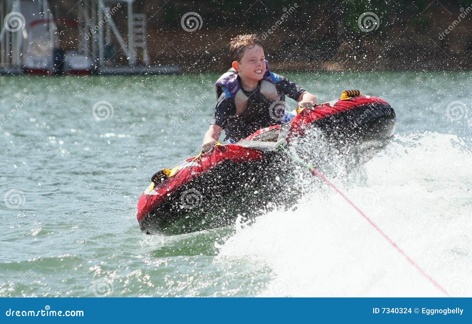 Boy Tubing stock photo. Image of spray, ride, lanier, fast 7340324