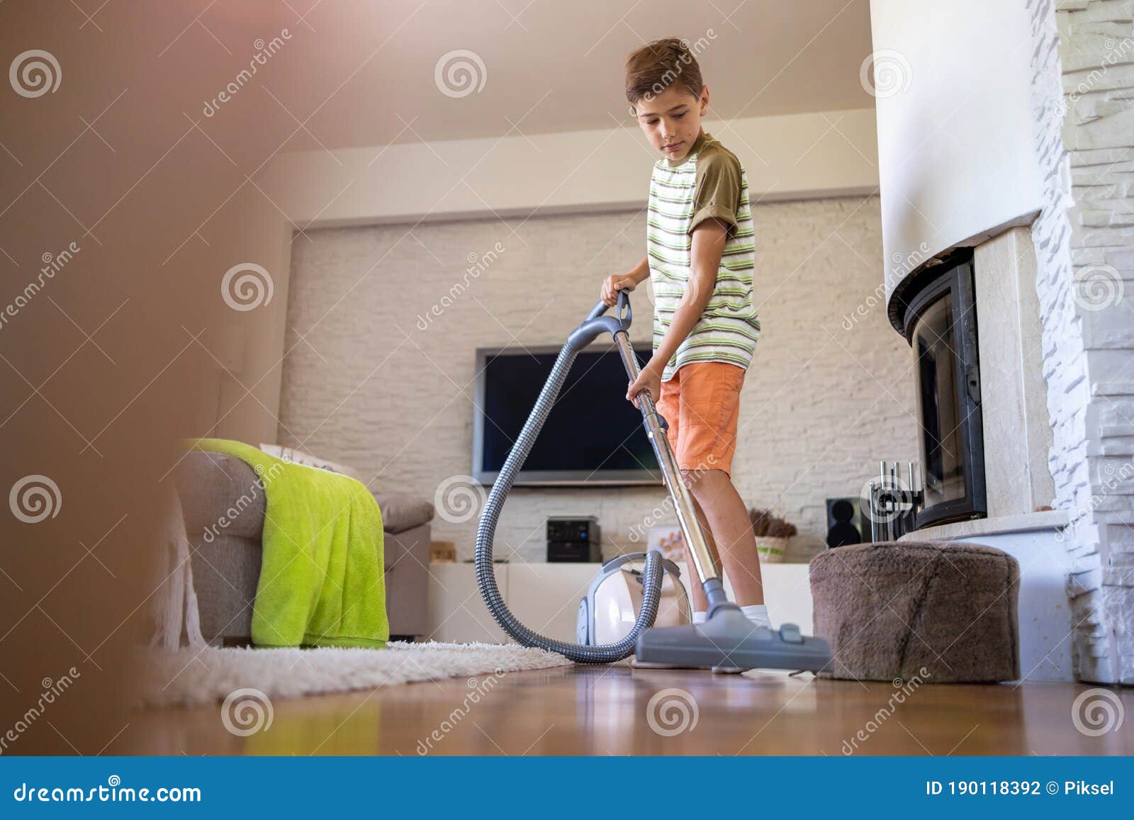 boy vacuuming floor