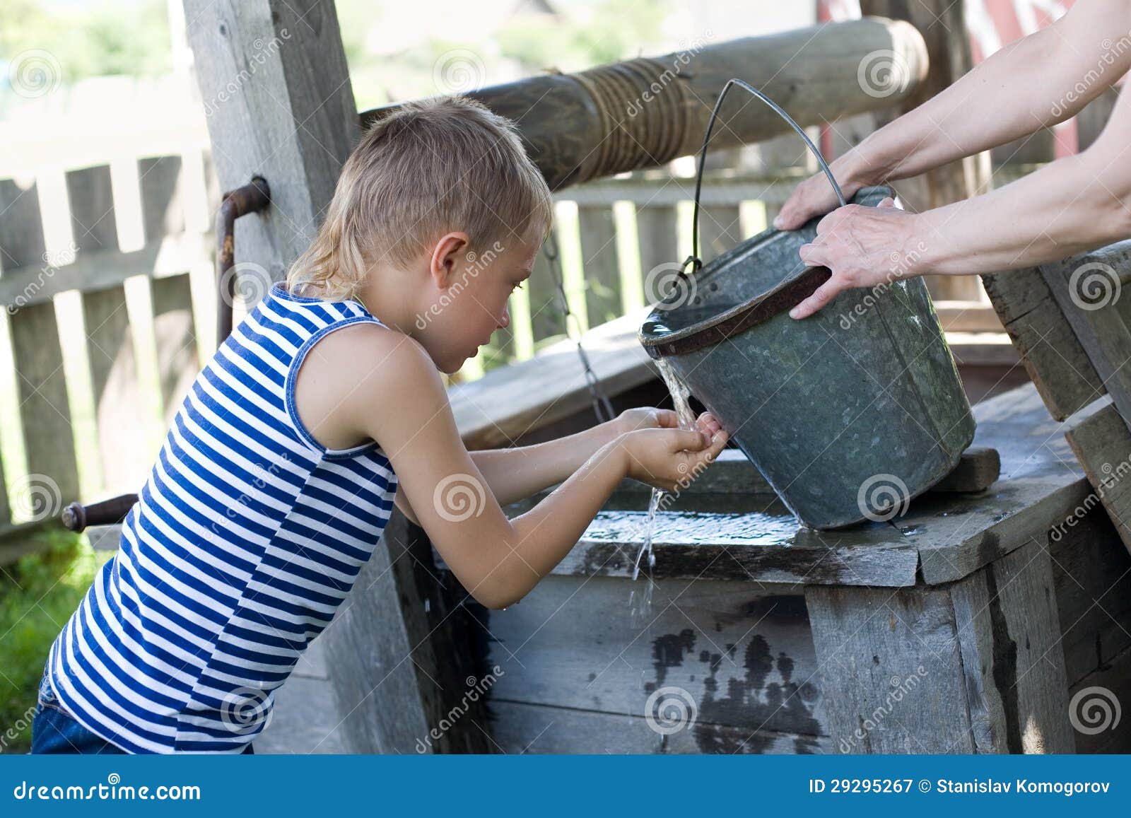 boy washes well water.