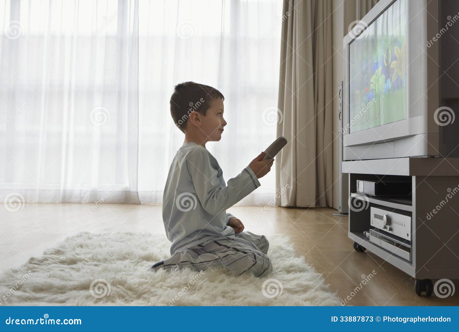 Boy Watching Cartoons In TV Stock Photos - Image: 33887873