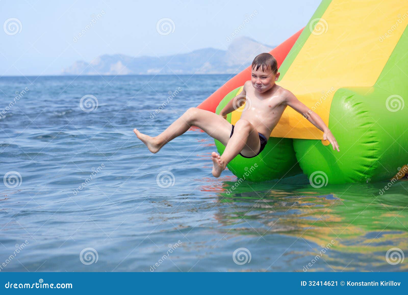 Boy On Water Slide Stock Image - Image: 32414621