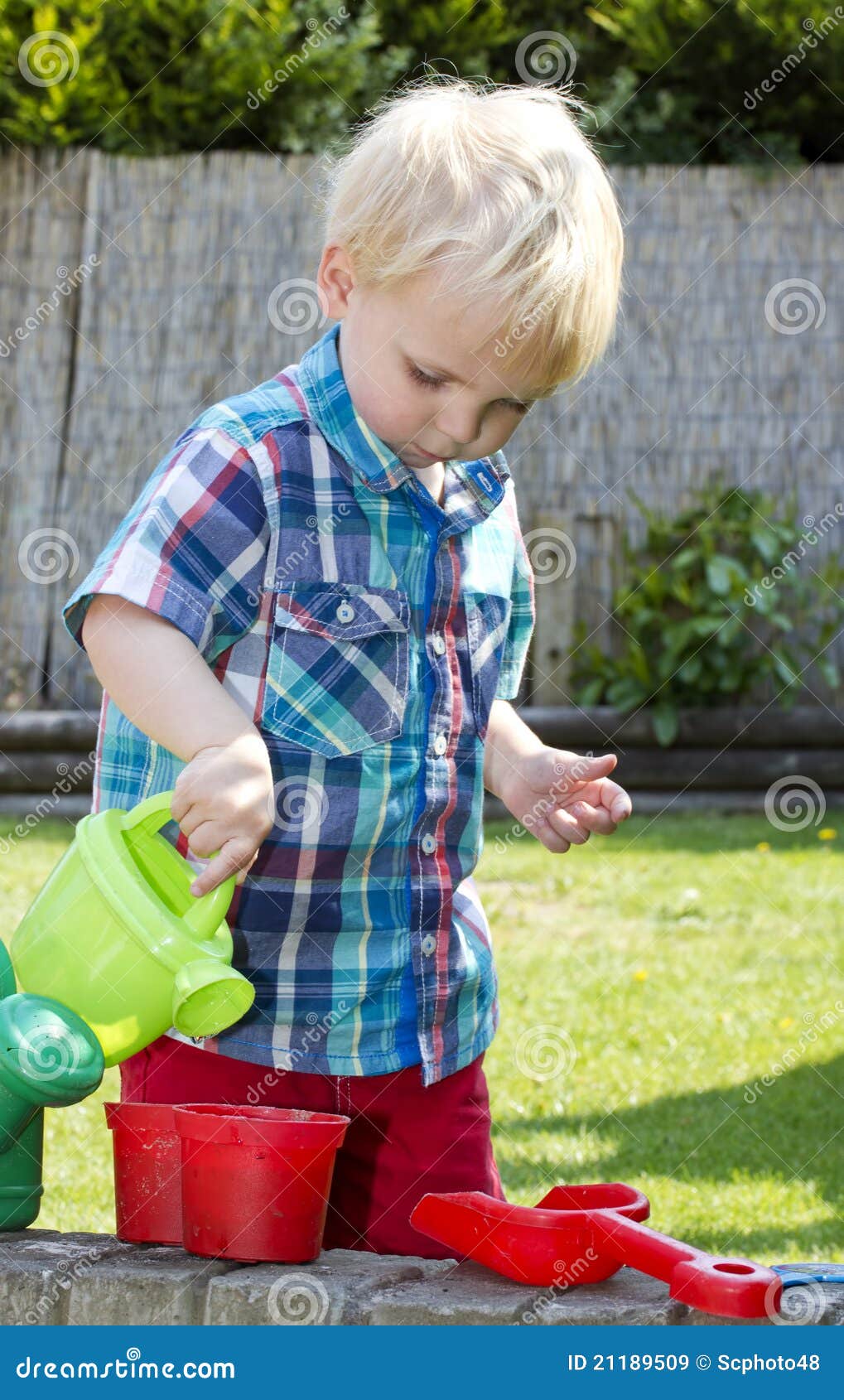 Boy with watering can stock image. Image of water, beautiful 21189509