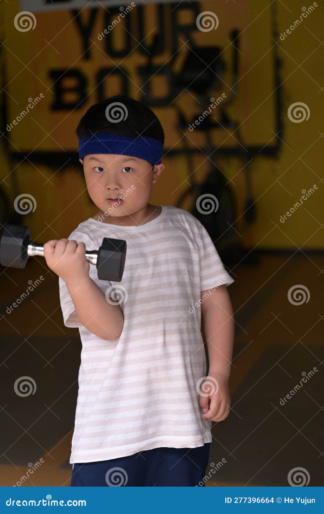 A Boy Wearing a Headband Exercising Stock Photo Image of people