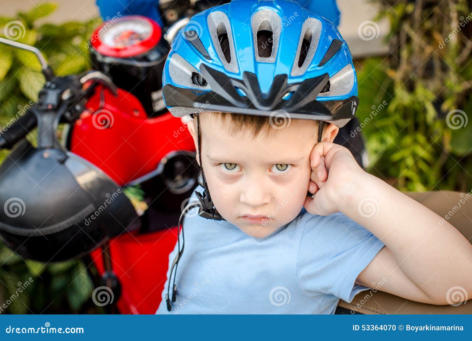 A Boy Wearing a Helmet Next To Motorcycle Stock Photo Image of